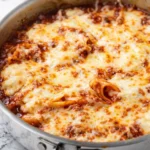 One-pan skillet lasagna featuring layers of pasta, cheese, and meat.