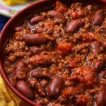 Delicious easy one pot chili simmering in a pot with beans and vegetables.